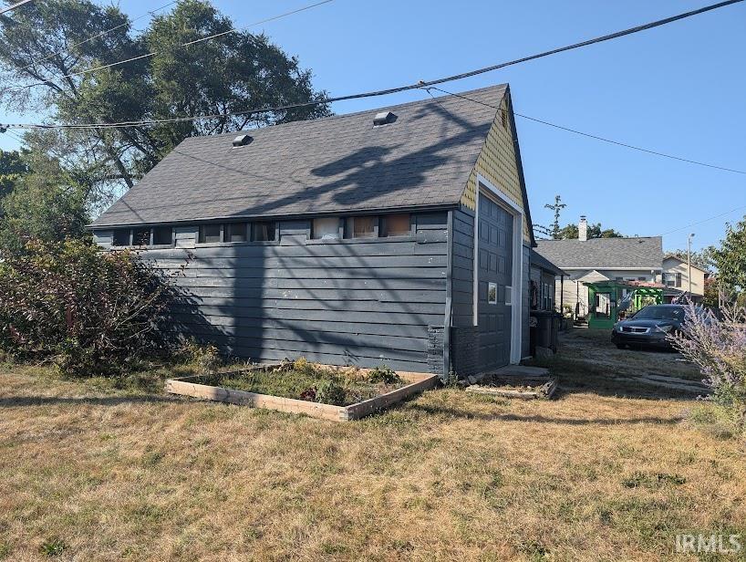 view of side of home with a lawn