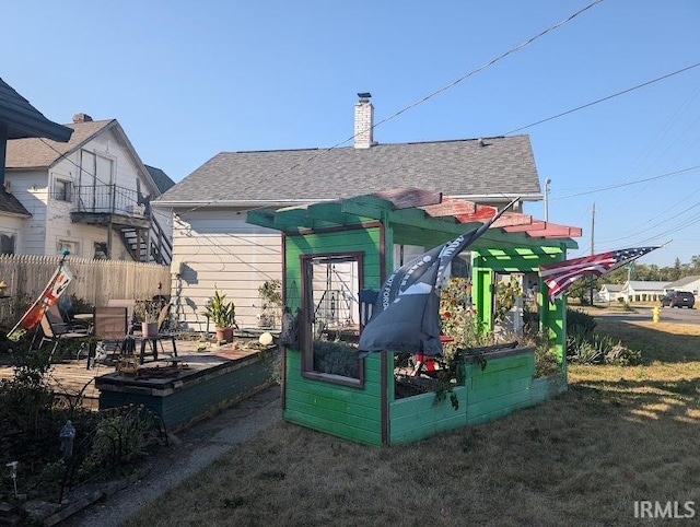 back of house with a pergola and a yard