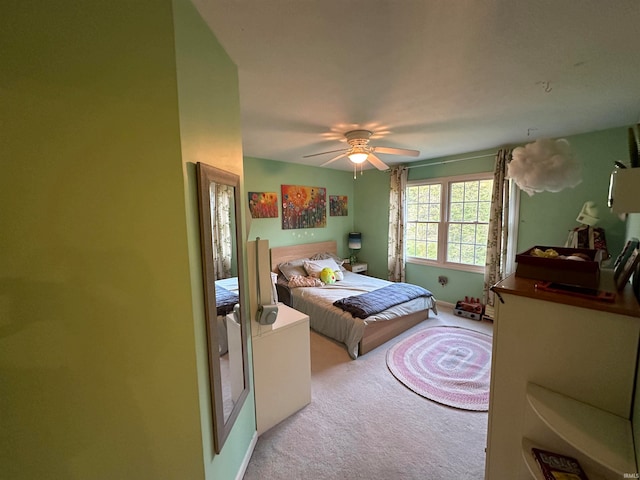 bedroom with ceiling fan and light colored carpet