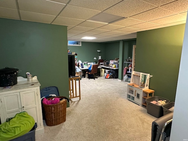 recreation room with light carpet and a paneled ceiling