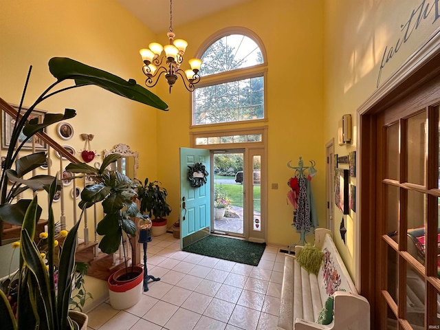 entrance foyer with a notable chandelier, light tile patterned floors, and a high ceiling