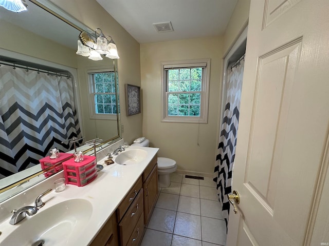 bathroom featuring walk in shower, vanity, toilet, and tile patterned floors