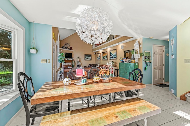 tiled dining space with a notable chandelier and vaulted ceiling