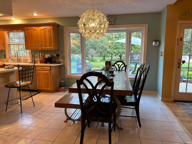 dining area featuring light tile patterned floors, sink, and a chandelier