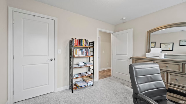 carpeted office featuring baseboards