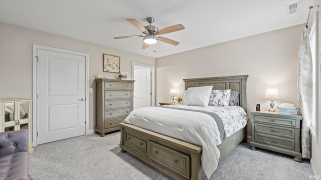 bedroom featuring baseboards, visible vents, light carpet, and ceiling fan