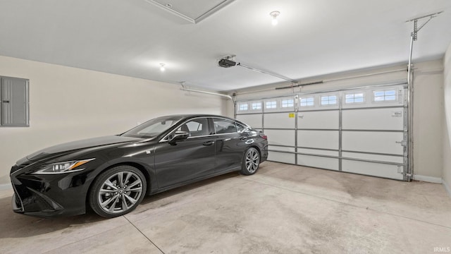 garage with a garage door opener and electric panel