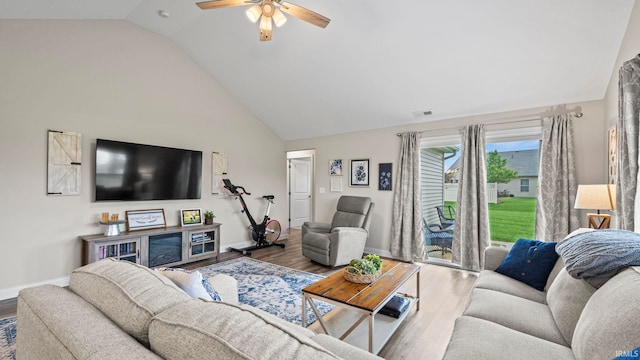 living area with high vaulted ceiling, a ceiling fan, visible vents, baseboards, and wood finished floors