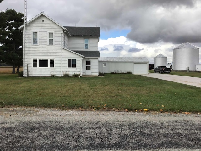 406 W 750 S, Star City, IN 46985 - view of front of property featuring a garage, roof with shingles, driveway, and a front lawn