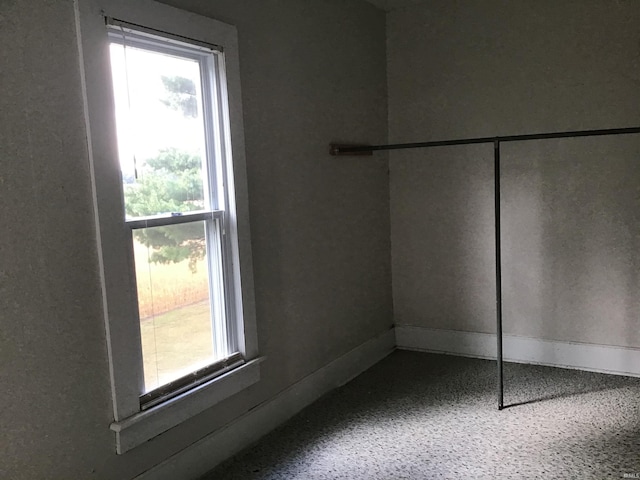 406 W 750 S, Star City, IN 46985 - unfurnished bedroom with multiple windows, speckled floor, and a closet