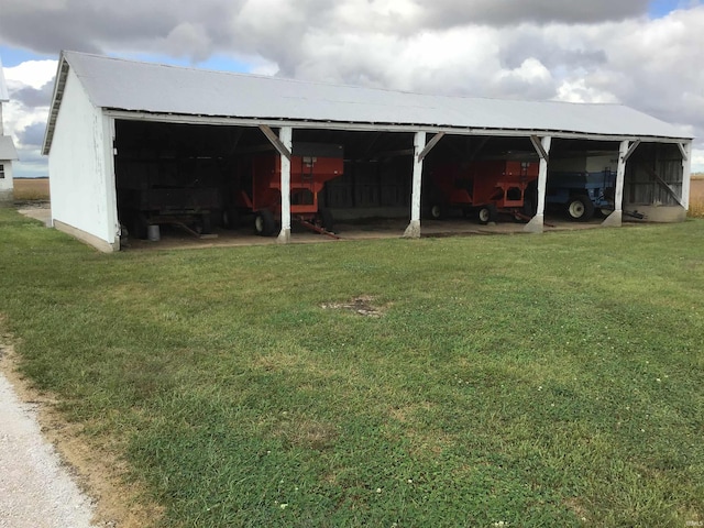 view of outdoor structure featuring a lawn