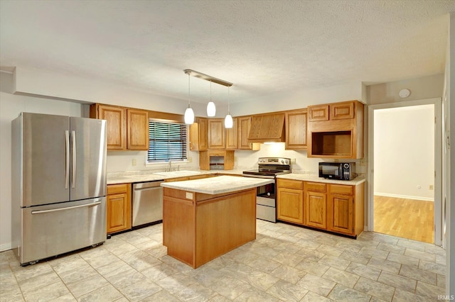 kitchen with a kitchen island, pendant lighting, stainless steel appliances, a textured ceiling, and sink