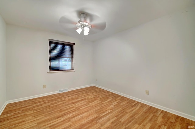 spare room with light wood-type flooring and ceiling fan