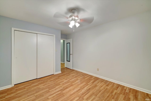 unfurnished bedroom featuring a closet, light wood-type flooring, and ceiling fan