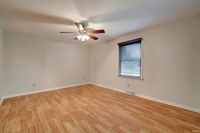 spare room with light wood-type flooring and ceiling fan