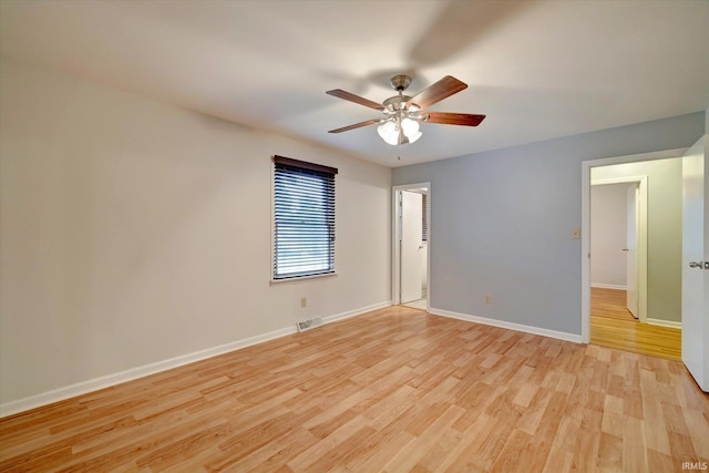 empty room with ceiling fan and light hardwood / wood-style floors