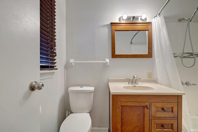 bathroom featuring walk in shower, vanity, and toilet