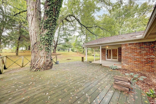 wooden deck featuring a yard