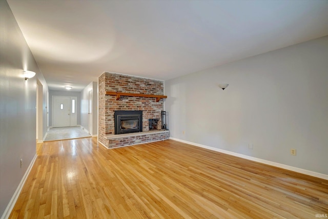 unfurnished living room featuring light hardwood / wood-style floors and a fireplace