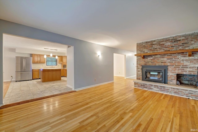 unfurnished living room with light hardwood / wood-style flooring and a fireplace