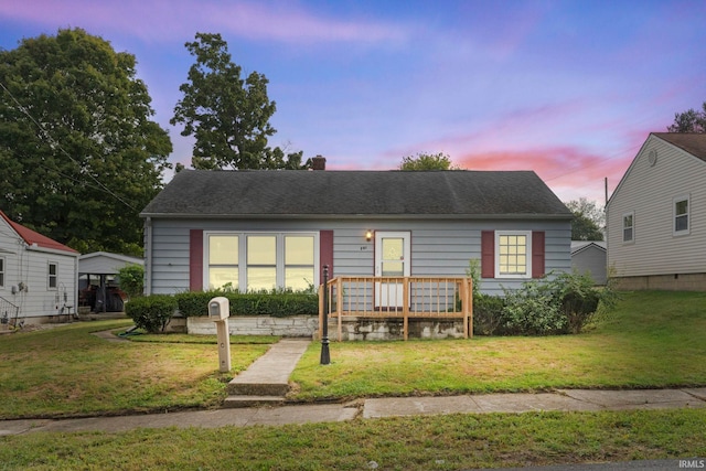 bungalow-style home featuring a yard