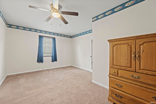 unfurnished bedroom featuring ceiling fan and light colored carpet