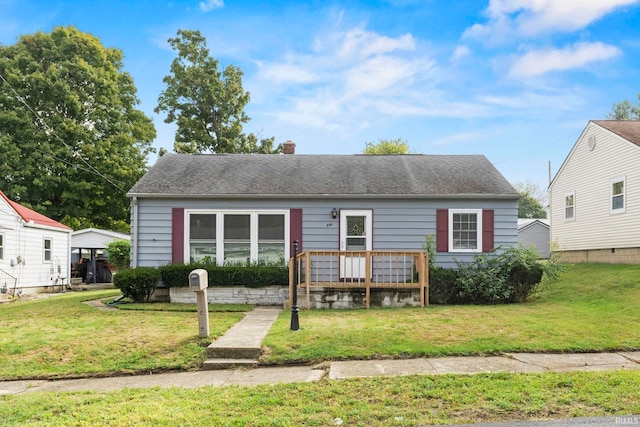 bungalow-style home featuring a deck and a front yard