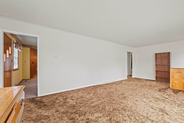 empty room featuring ornamental molding and carpet flooring