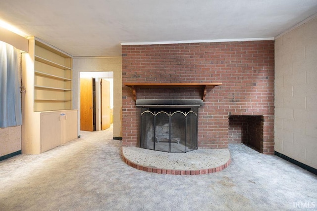 unfurnished living room with carpet flooring and a fireplace