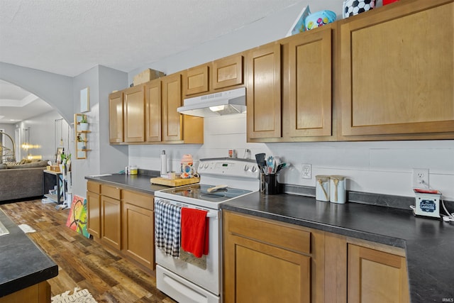 kitchen featuring white electric range oven, dark hardwood / wood-style floors, and a textured ceiling