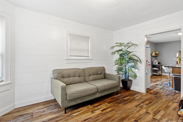 sitting room with dark hardwood / wood-style flooring