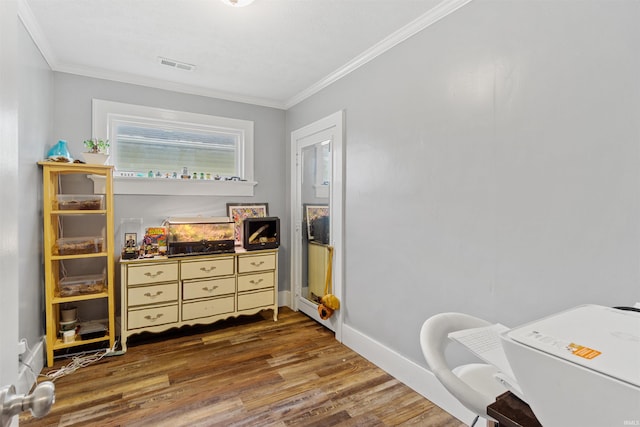 interior space with dark hardwood / wood-style flooring and crown molding