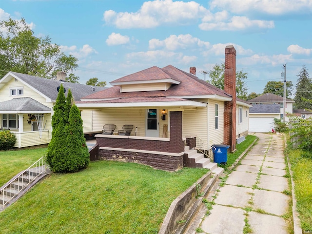 bungalow-style home with an outdoor structure, a garage, a porch, and a front yard