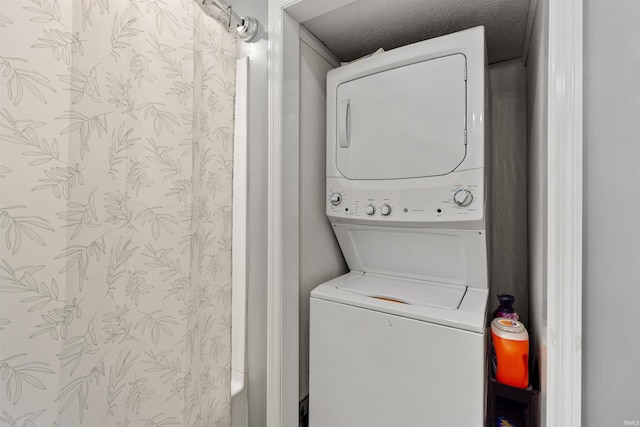 clothes washing area featuring stacked washer and dryer