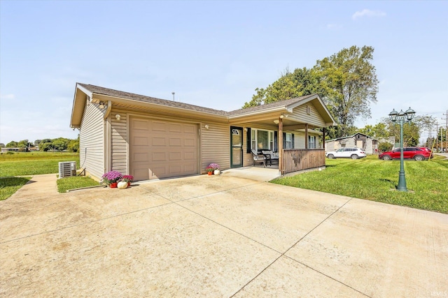 view of front facade featuring central AC unit, a garage, and a front lawn