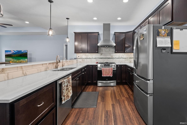 kitchen with pendant lighting, sink, wall chimney exhaust hood, stainless steel appliances, and dark hardwood / wood-style floors