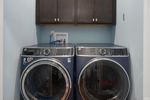 washroom featuring cabinets and separate washer and dryer