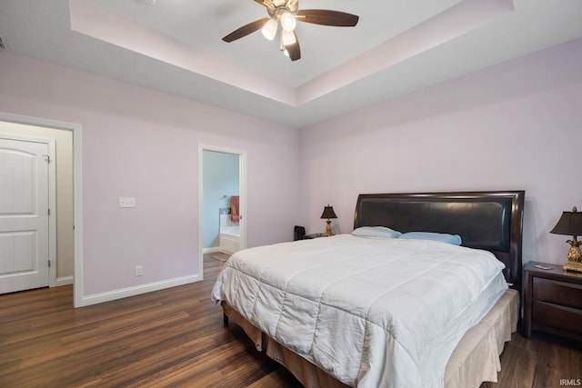 bedroom with ceiling fan, a raised ceiling, and dark wood-type flooring