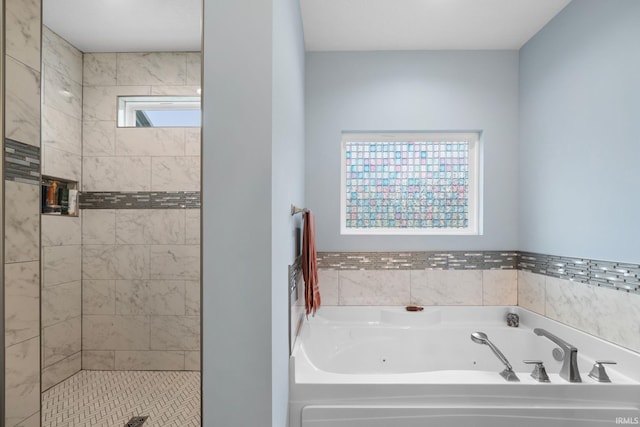 bathroom featuring shower with separate bathtub