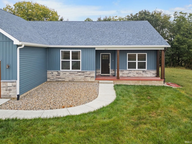 ranch-style home with a front yard and covered porch