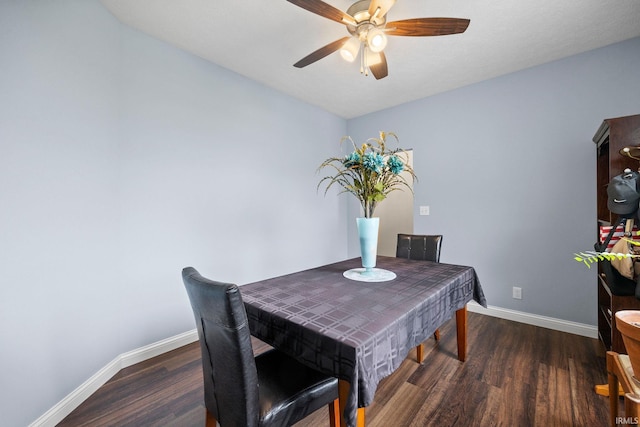 dining space with dark hardwood / wood-style flooring and ceiling fan