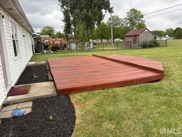 view of yard featuring a storage shed and a deck