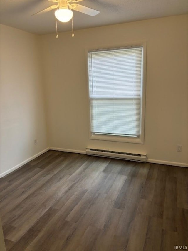 unfurnished room featuring baseboard heating, ceiling fan, and dark wood-type flooring