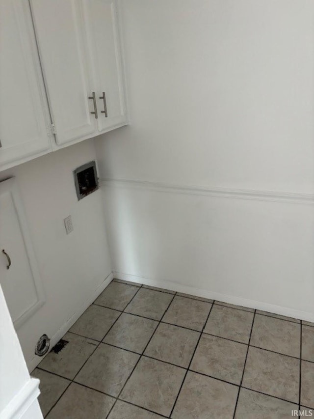 laundry room with cabinets and light tile patterned flooring