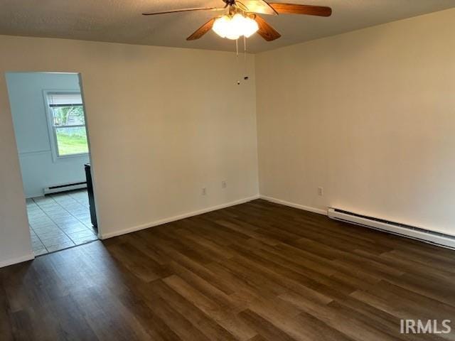 unfurnished room featuring ceiling fan, a baseboard radiator, and dark hardwood / wood-style floors