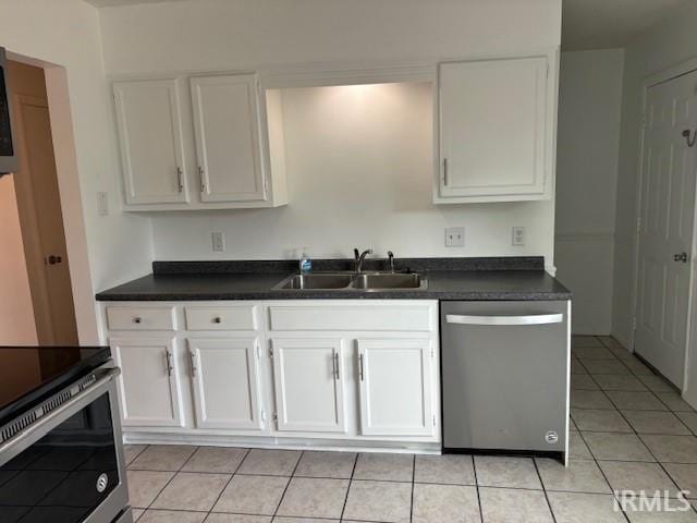 kitchen featuring sink, light tile patterned floors, stainless steel appliances, and white cabinets