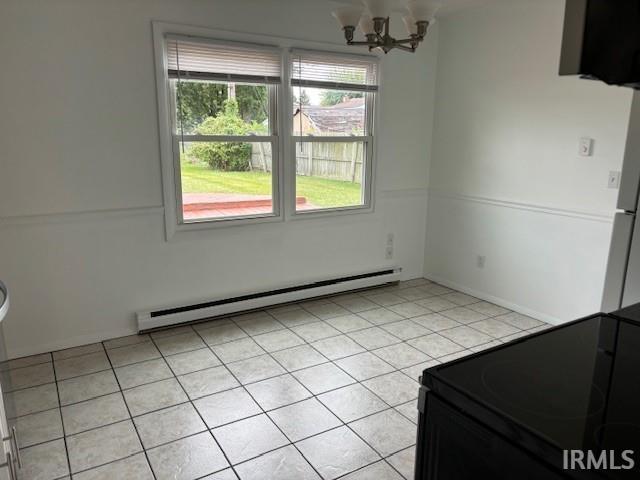 unfurnished dining area featuring baseboard heating, light tile patterned floors, and a notable chandelier