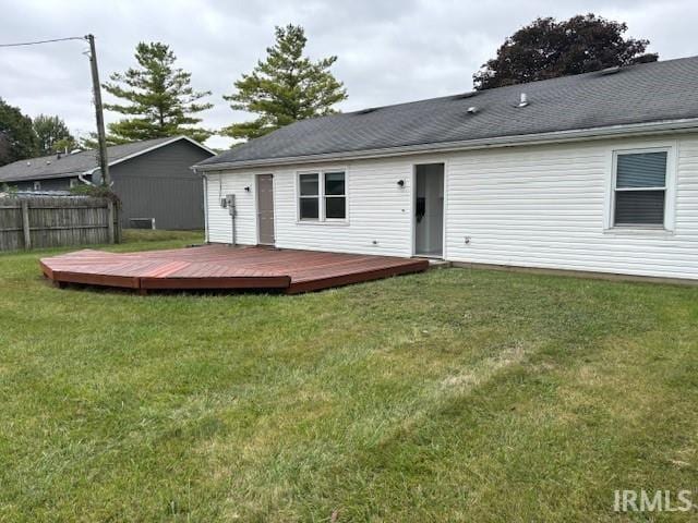 back of house featuring a yard and a deck