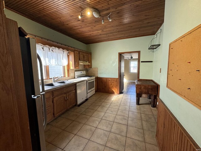 232 S Main St, Avilla, IN 46710 - kitchen with wooden ceiling, a sink, wainscoting, under cabinet range hood, and white appliances