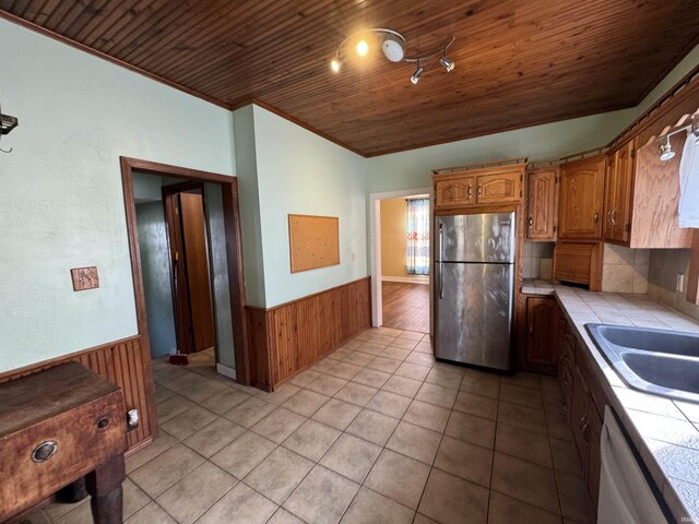 232 S Main St, Avilla, IN 46710 - kitchen with a wainscoted wall, tile countertops, wood ceiling, and freestanding refrigerator